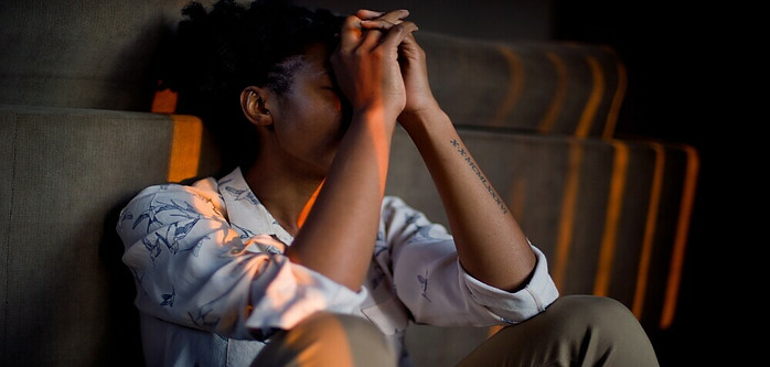 Girl sitting on the floor being emotional